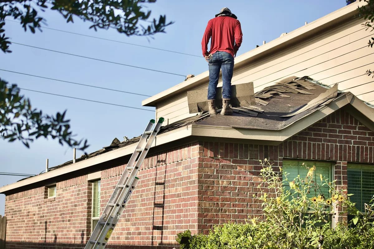 Roofing crew working on a residential roof during an active exterior project